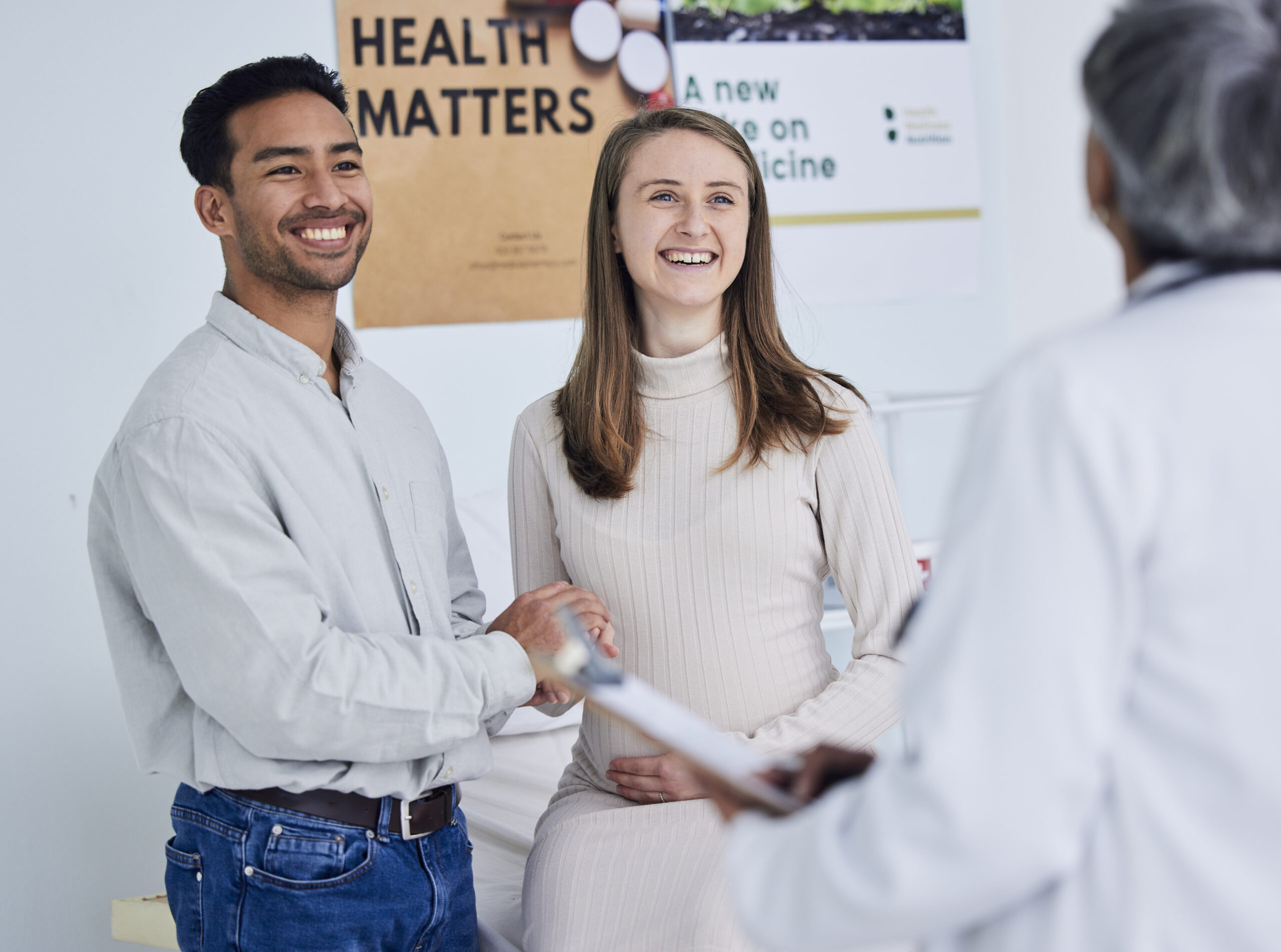 Family, planning and pregnant couple with doctor in consultation office for healthcare exam.