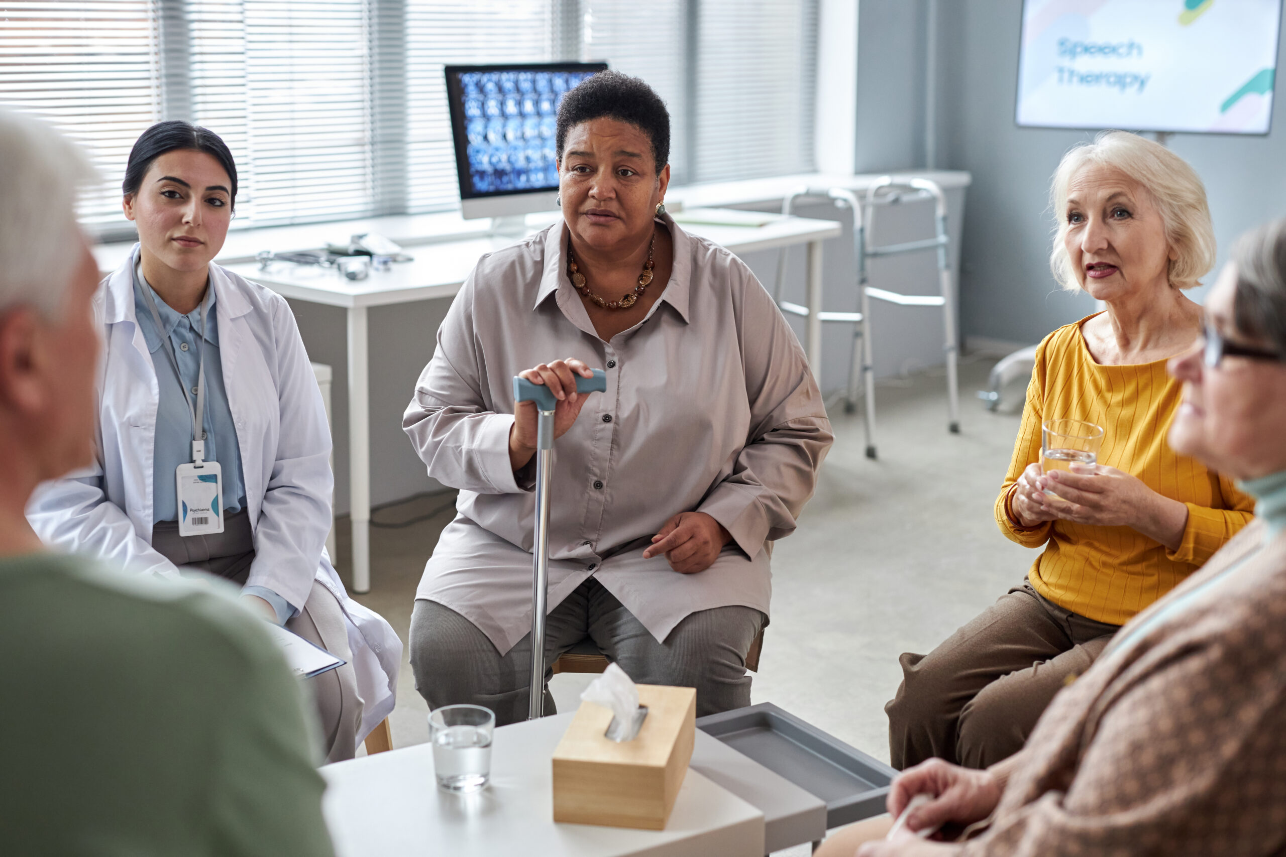 Portrait of senior black woman speaking in mental health support group for elderly people